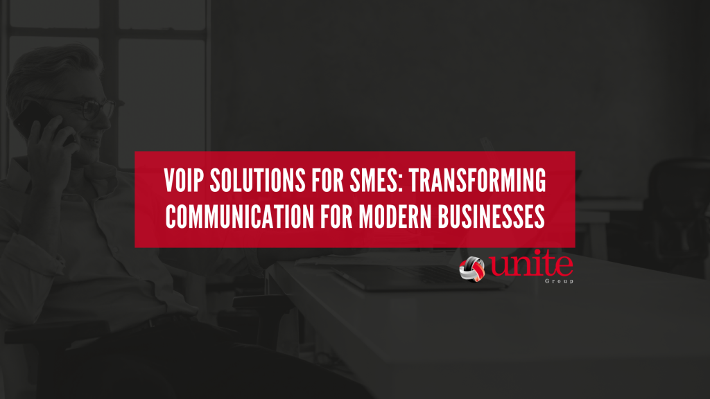 man at a desk on the phone. text reads VoIP Solutions for SMEs: Transforming Communication for Modern Businesses