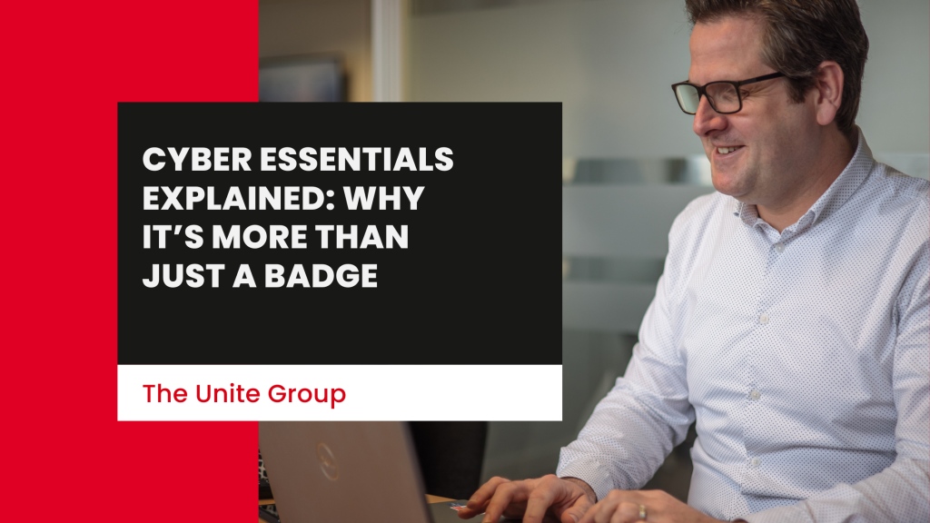 man & woman both working at The Unite Group smiling looking at a laptop