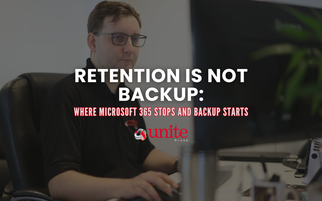 A unite group employee working at a desk on a computer-Retention Is Not Backup: Where Microsoft 365 Stops and Backup Starts
