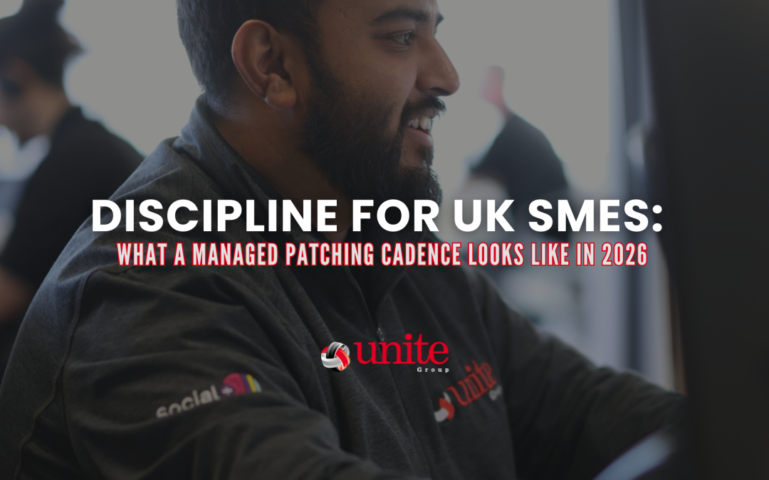 A Unite Group employee sat at a desk smiling -Patch Discipline for UK SMEs: What a Managed Patching Cadence Looks Like in 2026
