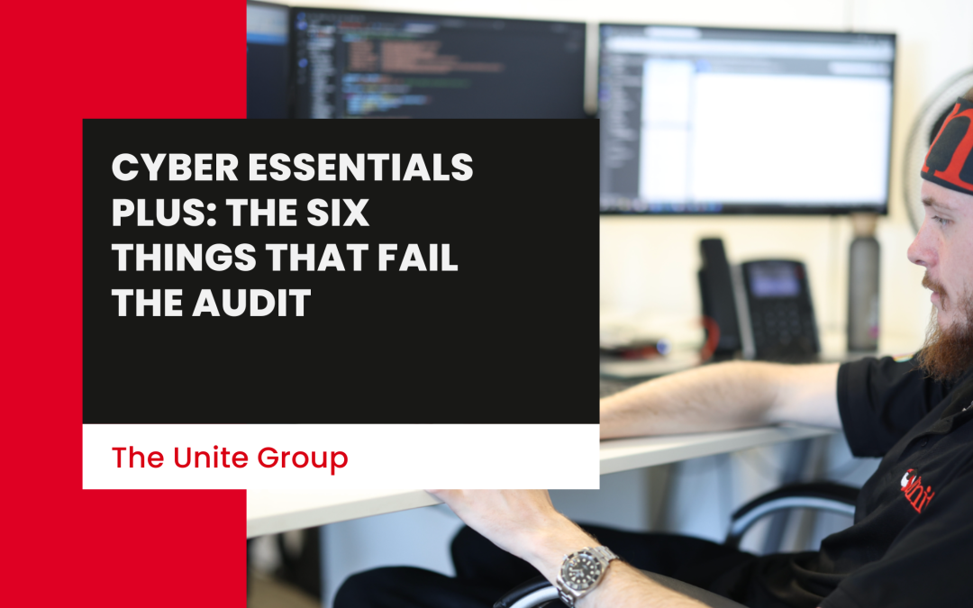 A unite group employee sat on a desk working on a computer -Cyber Essentials Plus: The Six Things That Fail The Audit