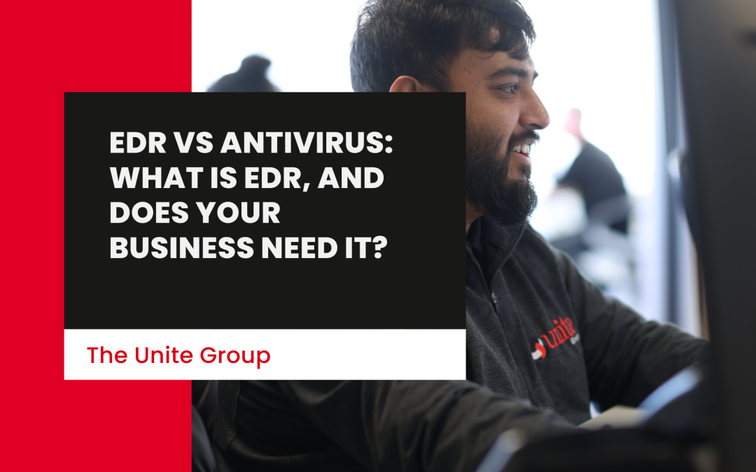 A unite group employee sat at a desk smiling -EDR vs Antivirus: What Is EDR, And Does Your Business Need It?