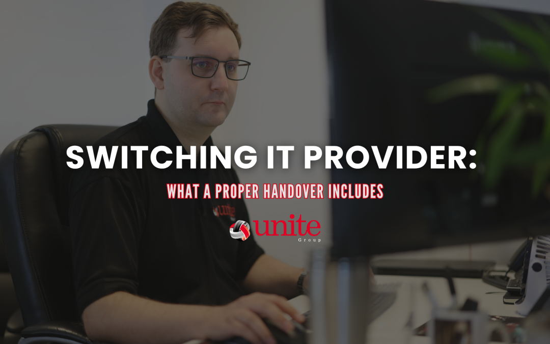 A Unite Group employee sat at a desk on a computer - Switching IT provider: what a proper handover includes